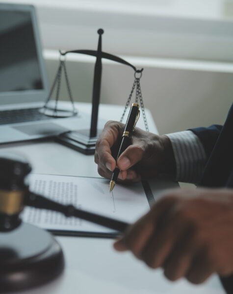 Business and lawyers discussing contract papers with brass scale on desk in office. Law, legal services, advice, justice and law concept picture with film grain effect